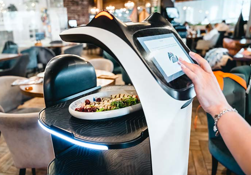 Restaurant manager using AI-powered solution to process customers' orders